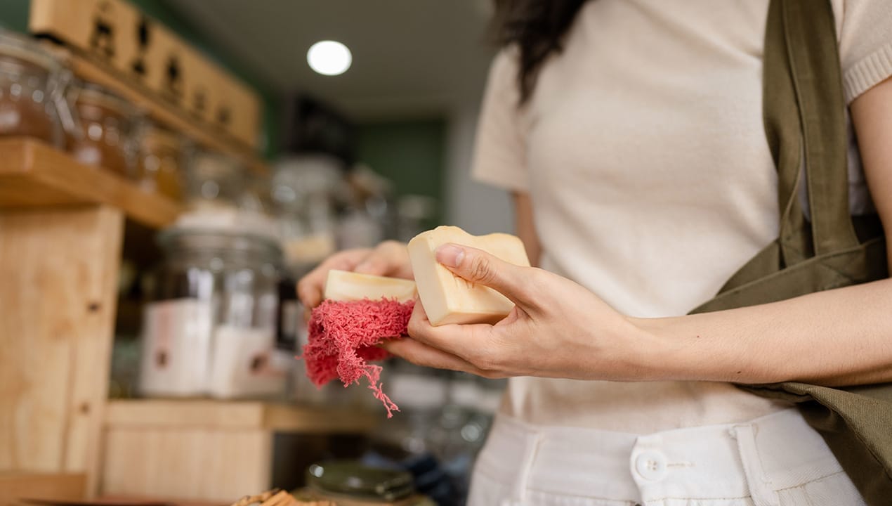 Female friendship buying ecological bio organic handmade soap bar in plastic waste free shop.