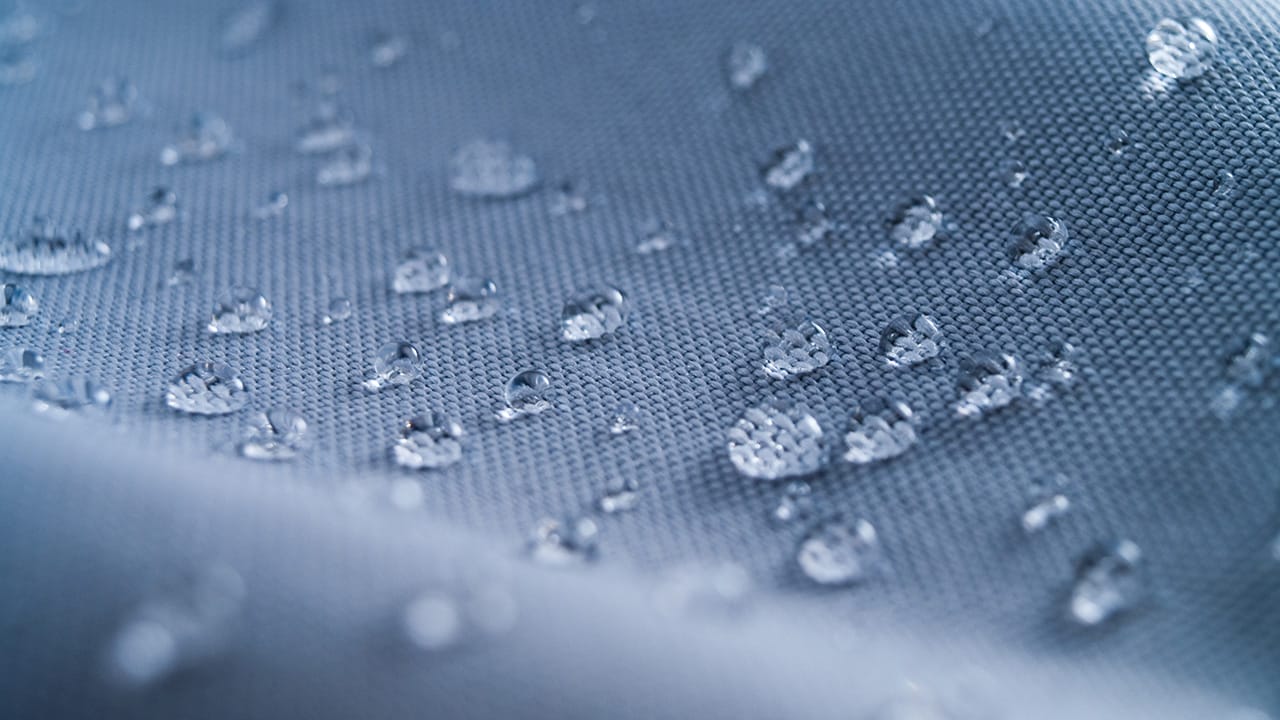 Macro shot of water rain drops on waterproof textile jacket. Extreme depth of field. Please visit my portfolio for different shots of this subject.